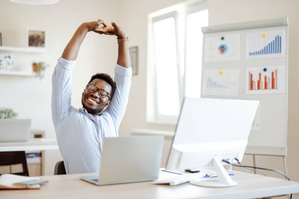 Person stretching and enjoying a calm moment near a window during a work break